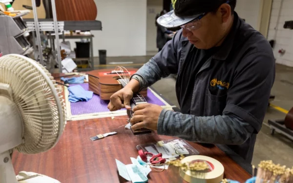 Luthier colocando cuerdas en una guitarra Martin en Navojoa, México